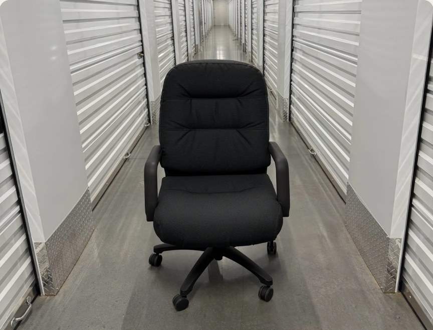 Black executive office chair in a storage hallway